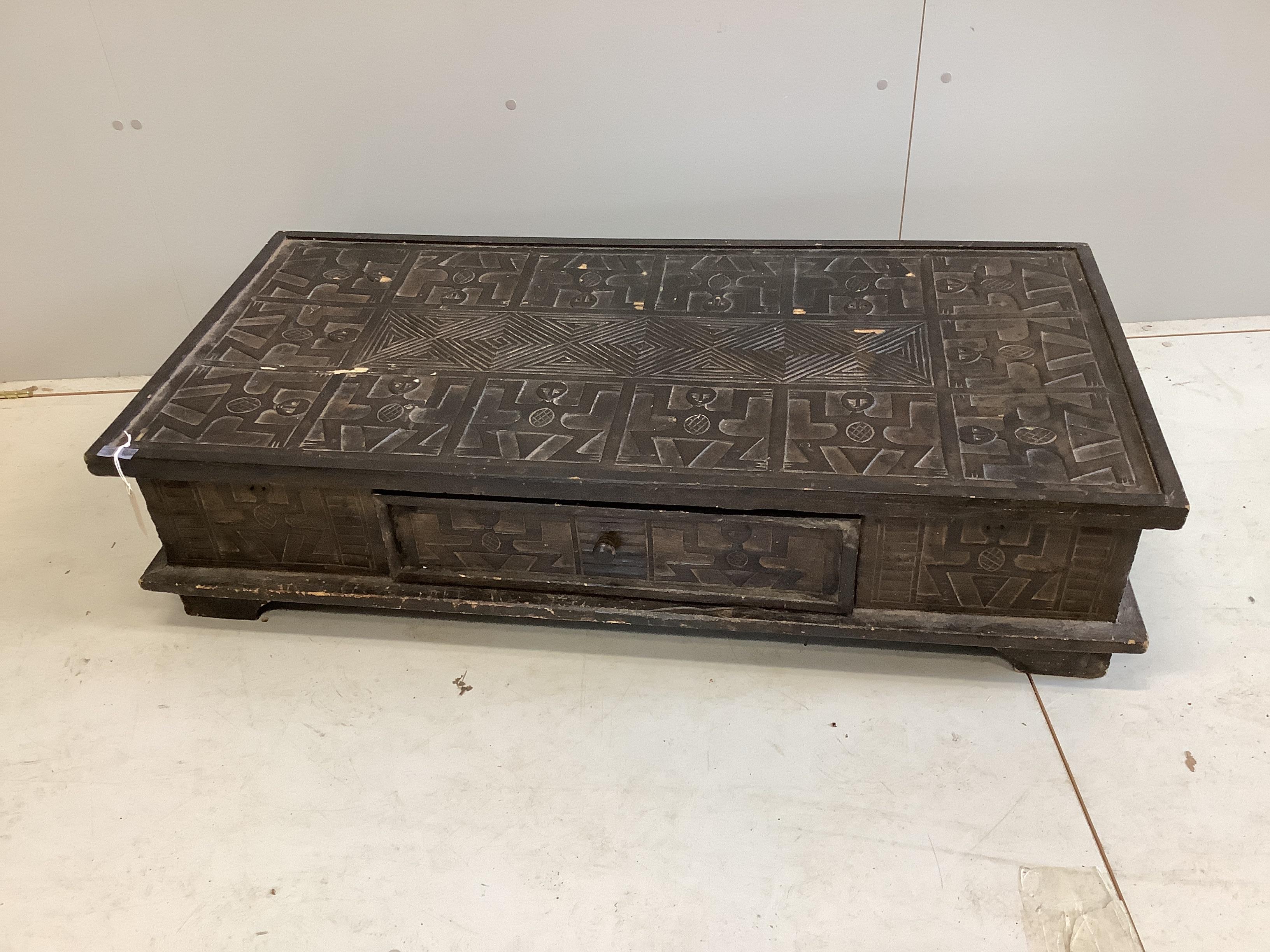 An African rectangular carved hardwood low table, width 122cm, depth 60cm, height 29cm